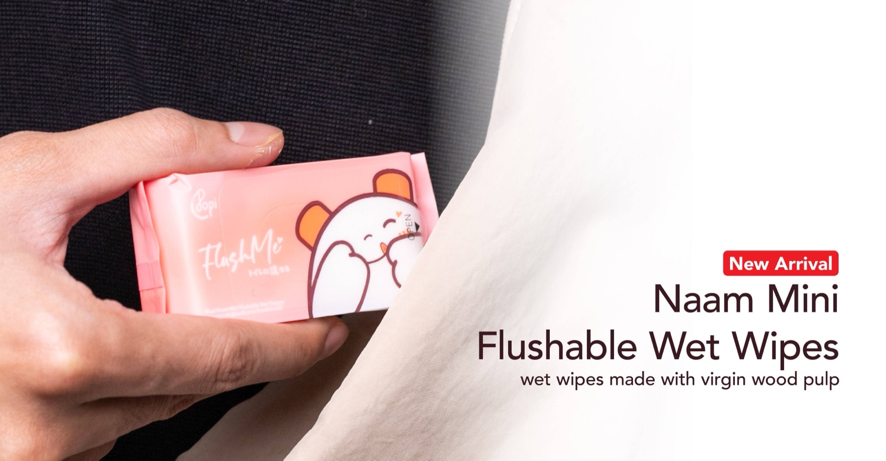 Naam Mini flushable wet wipes held in a hand